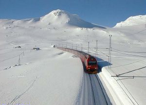 Train passes through high snow, with a gap left and right.