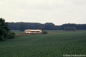 DMU in the middle of green fields.
