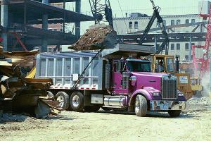 USA 4-axle dump truck loaded by an excavator.